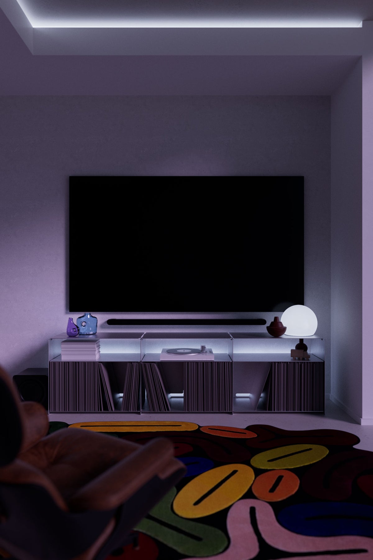 Modular aluminium TV unit under a wall-mounted TV in a moody living room